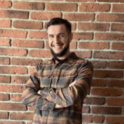 Damian standing close to wall